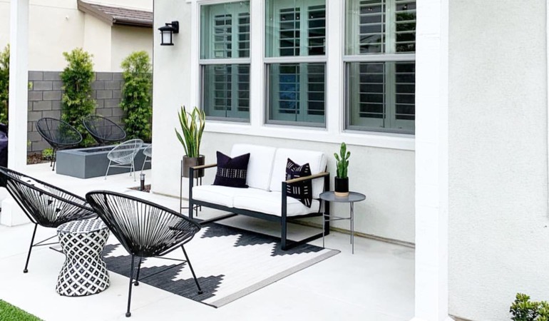 Spending a few hours weeding and mulching can help give you an outdoor oasis. An outside patio with plantation window treatments