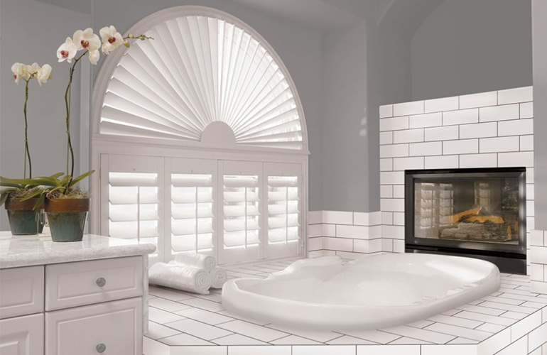 Our Specialists Installed Shutters On A Sunburst Arch Window In Indianapolis, IN arch window with white polywood shutters in a large bathroom