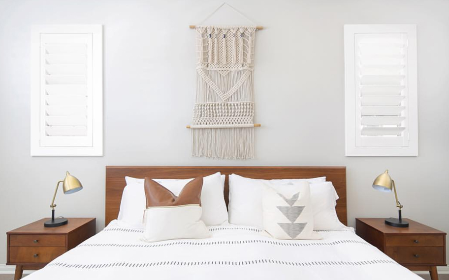 Custom-fitted louvered shutters provide excellent nighttime privacy in Fort Myers. Photo Credit: Audrey Crisp Louvered shutters in a bedroom.
