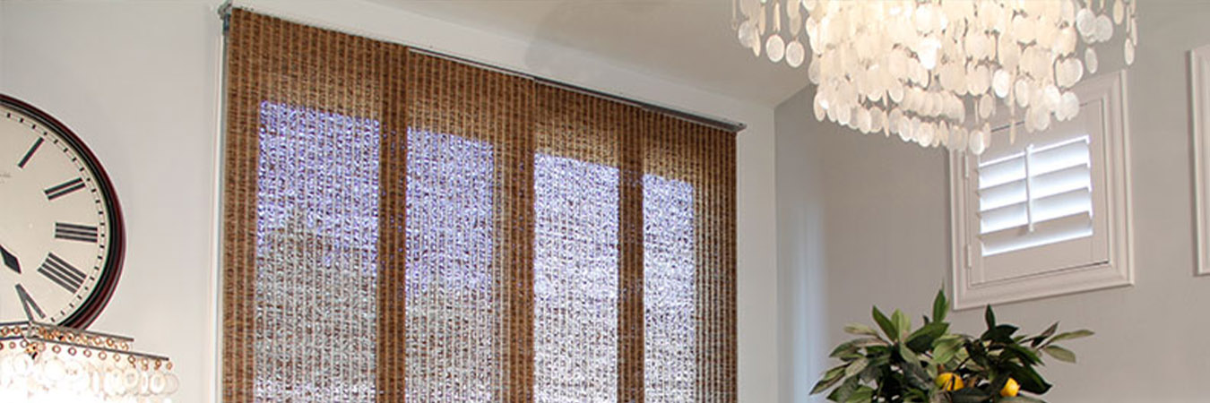 Woven brown shades in a classic style dining room
