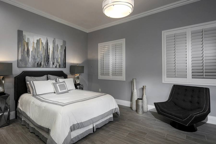 Close your custom Polywood shutters to beat the heat and keep your Fort Myers bedroom cool. White Polywood shutters on bedroom windows