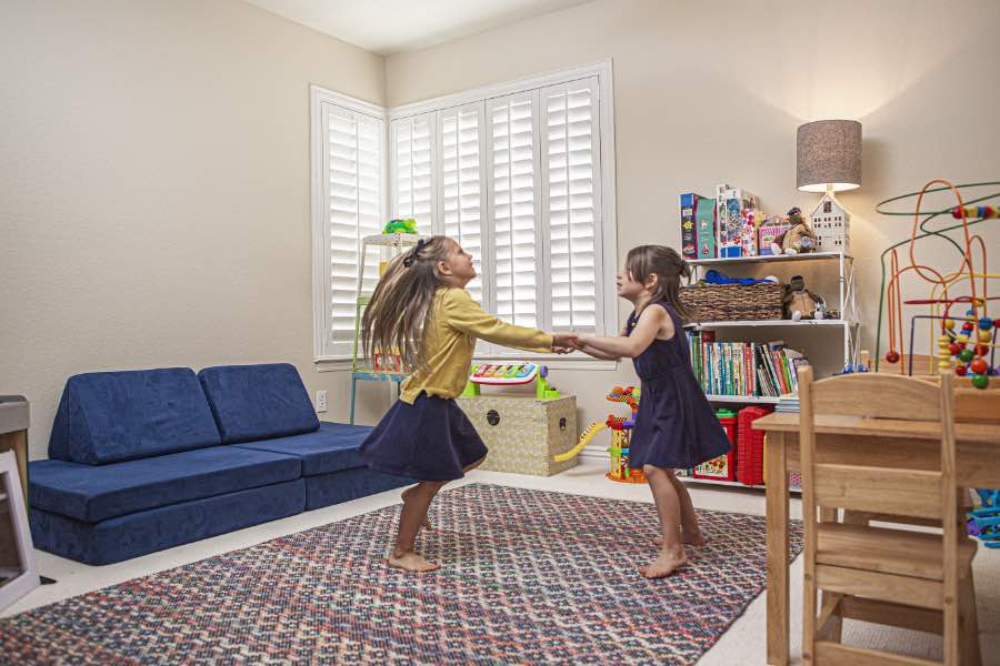 Choose Polywood shutters for durable, kid-friendly great room window treatments in Fort Myers. Polywood shutters on multiple windows in a sitting area