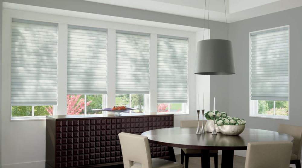 Custom cordless roller shades have a clean look and are appropriate for any room. Cordless motorized shades in a Fort Myers dining room