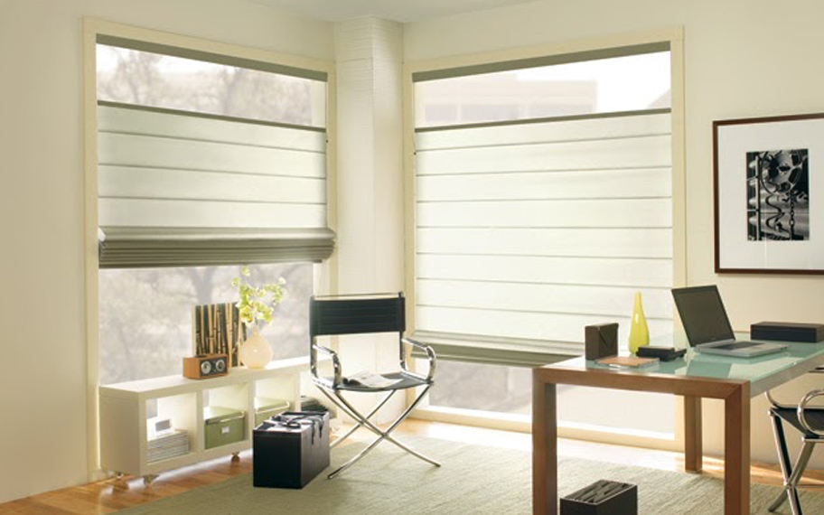 Upgrade your windows with stylish window shades or shutters in Fort Myers. Stylish sheer shades in the corner of a modern office.
