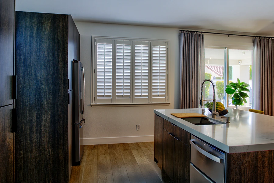 White Polywood shutters on a kitchen window