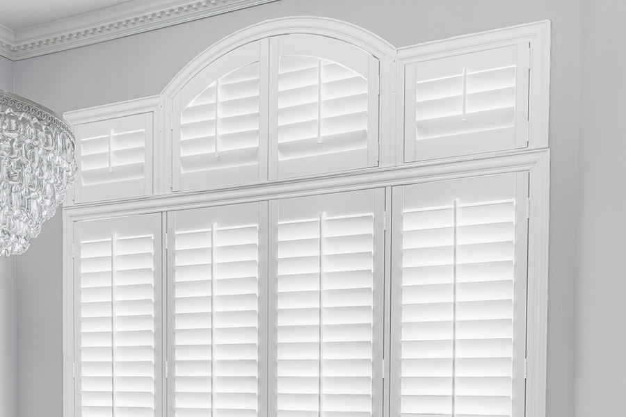 Customize your Palladian windows with white Polywood shutters in Fort Myers. White Polywood Palladian windows in a dining room.