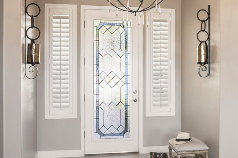 Polywood shutters offer flexibility on the brightness of natural light in Fort Myers. Sidelight windows with white polywood shutters in a foyer.